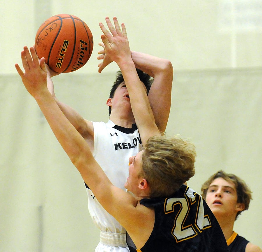 <who>Photo Credit: Lorne White/KelownaNow </who>Logan Kam of the Owls and Hunter Walloch of the Huskies collide in the key.