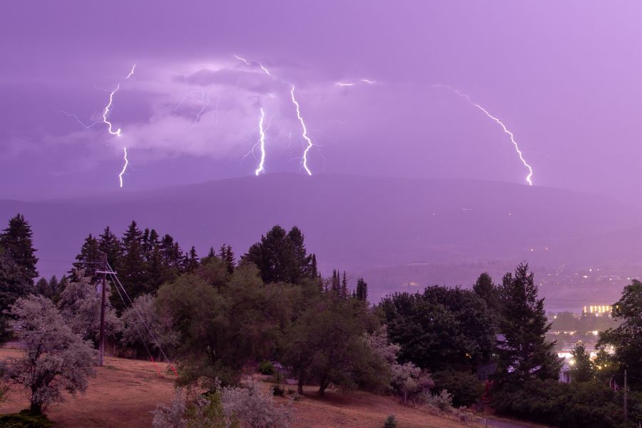 <who>Photo Credit: NowMedia</who> "Sheet" lightning illuminates the land as forks appear in the distance