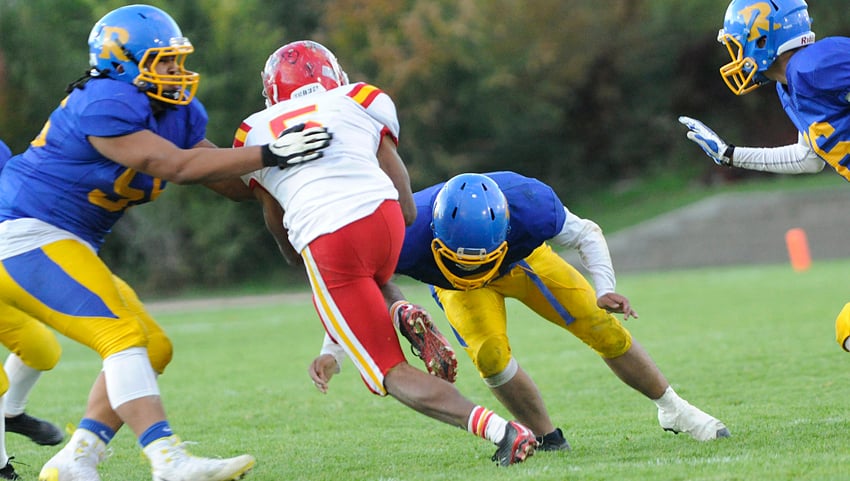 Bear Akachuk, left, and Prince Manongdo team up to stop the Hawks' Nathan Hausermann.