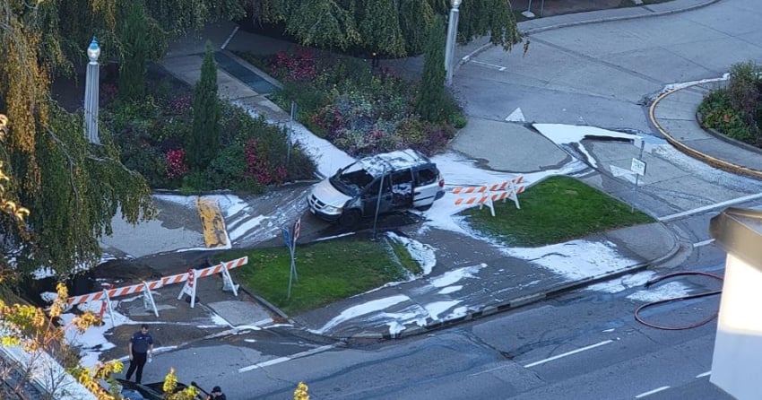 Minivan with containers of gasoline inside lit on fire near entrance to ...