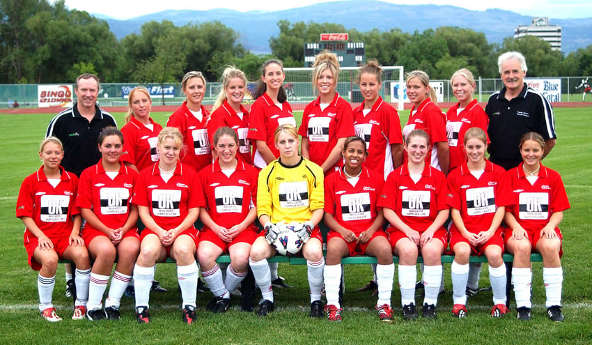 <who>Photo Credit: Lorne White/KelownaNow </who>The 2004 edition of the Kelowna Challenge of the Pacific Coast Soccer League: From left, front: Janelle Smith, Jen Wilson, Carla Hartling, Katie Quirk, Jeanette Paine, Megan Ferdinand, Lisa Goodgrove, Katie Bush, and Shelagh Mitchell. Back: Mike Shepherd (coach), Kristi Egilson, Paisley Edmonds, Anna Lovick, Bethany White, Brittany Heinrich, Whitney Agassiz, Lindsay Maier, Tenille Tuppin and Peter Rochfort (coach). "Many of our players played for university or college teams," recalled one of the team members. "And when they were back in town this was the perfect summer team to keep our skills sharpened." 
