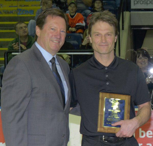 <who> Photo Credit: Kelowna Rockets </who> Scott Hoyer (right) holds his award from the BC Hockey Hall of Fame. 