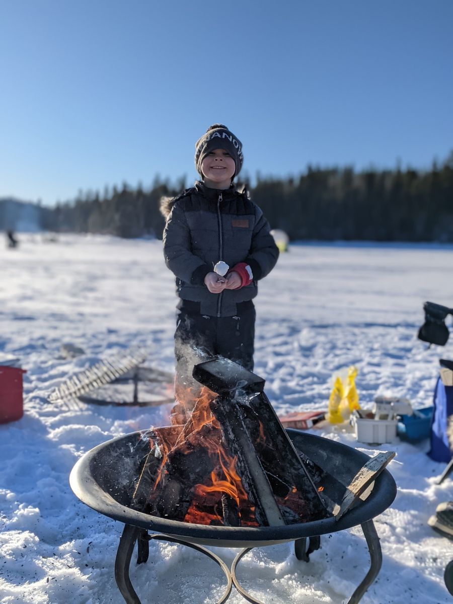 Ben Loewen roasting marshmallows in a KelownaNow toque