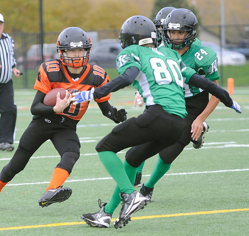 <who>Photo Credit: Lorne White/KelownaNow </who>Quarterback Nate Beauchemin of the Lions runs into trouble — in the form of the Riders' Dylan Moreau (80) and Zac Leinweber (24).