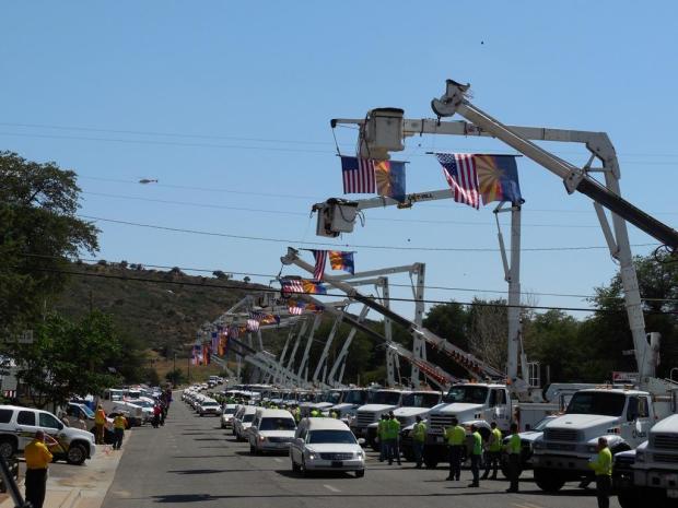 <who>Photo Credit: Wikipedia</who>The funeral procession for the 19 firefighters killed in the Yarnell Hill Fire.