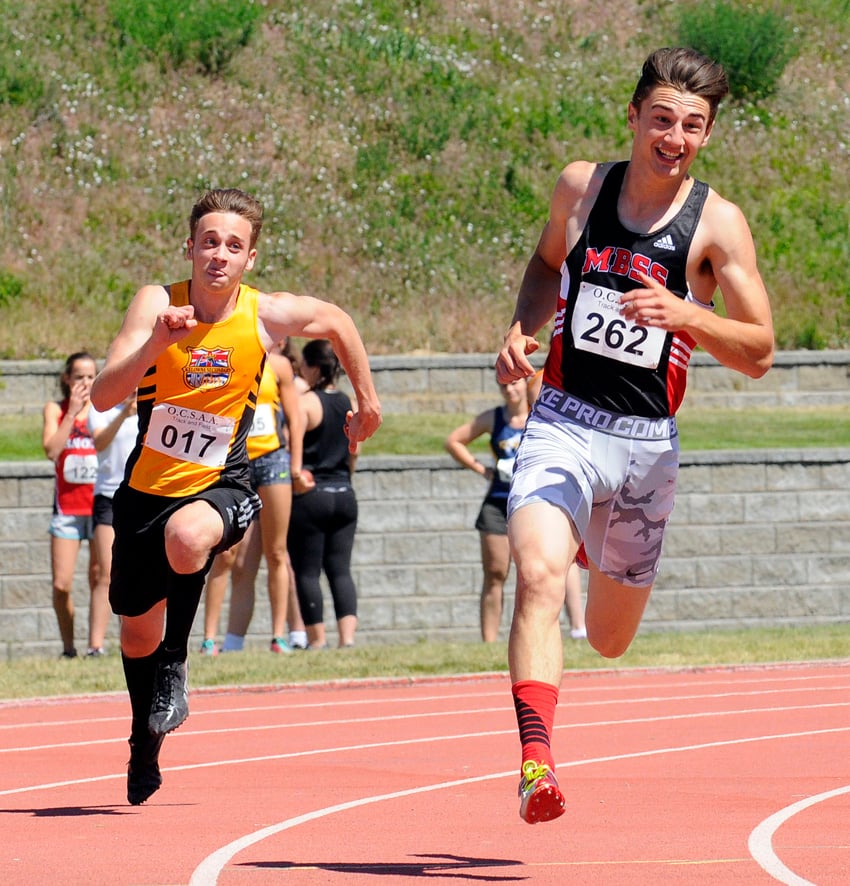 Jesse Benneke of the Mt. Boucherie Bears approaches the straight stretch on the way to a win in the senior 200-metre event. Trailing is Jean-Marc Hoffman of KSS. 