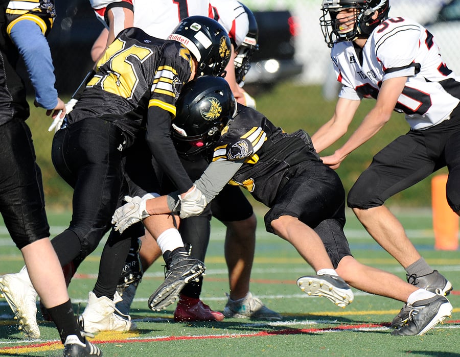 Sam Woychuk and Chase Hunter team up to stop the Ravens on a third-down run.