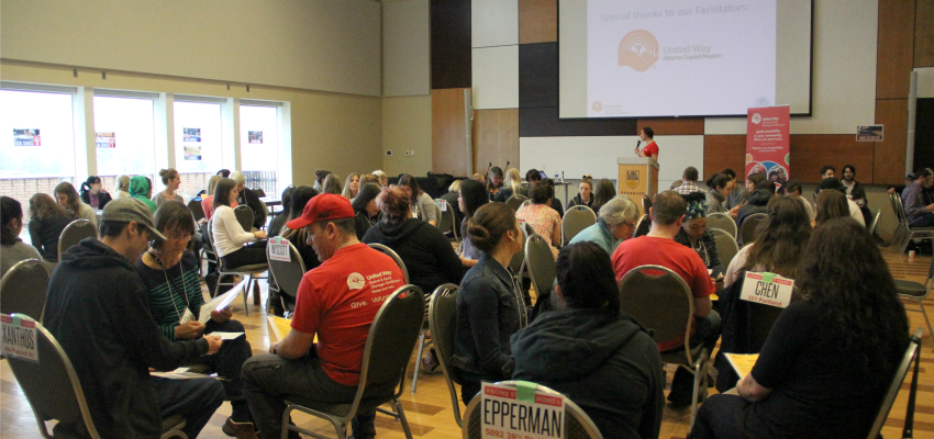 <who> Photo Credit: KelownaNow. </who> Almost 100 people from Kelowna gathered at UBCO to take part in the poverty simulation. 