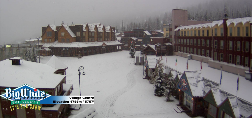 <who> Photo Credit: Big White webcams. </who> Snow now covers the village at Big White. 