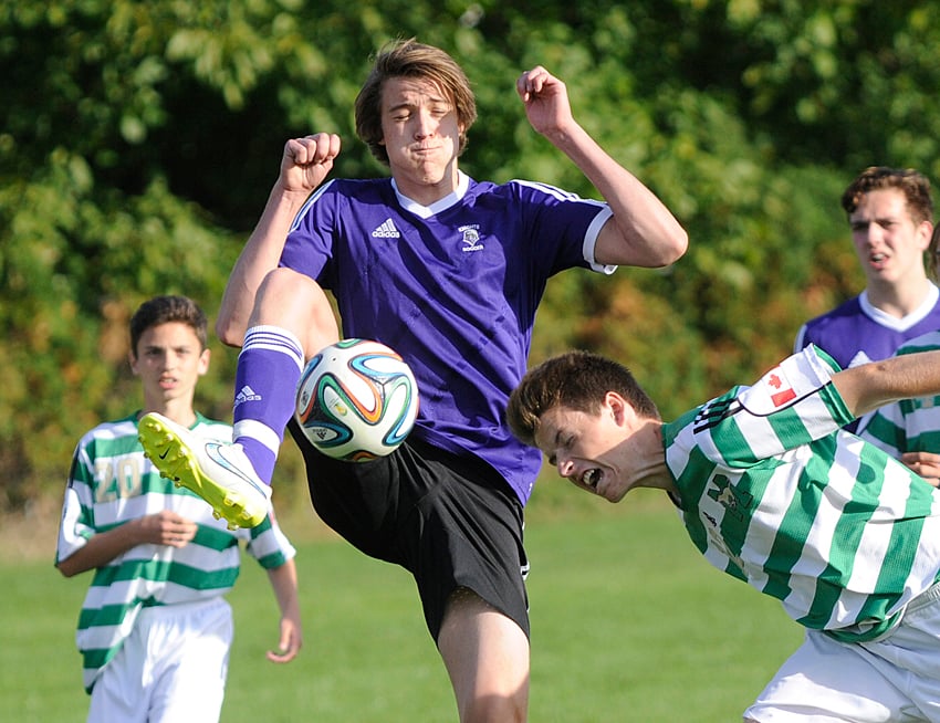 <who>Photo Credit: Lorne White/KelownaNow </who>Justin Ziebart of the Immaculata Mustangs gets his head on the ball and Sean Klassen of the Kelowna Christian School Knights responds by lifting his leg in front of the shot.