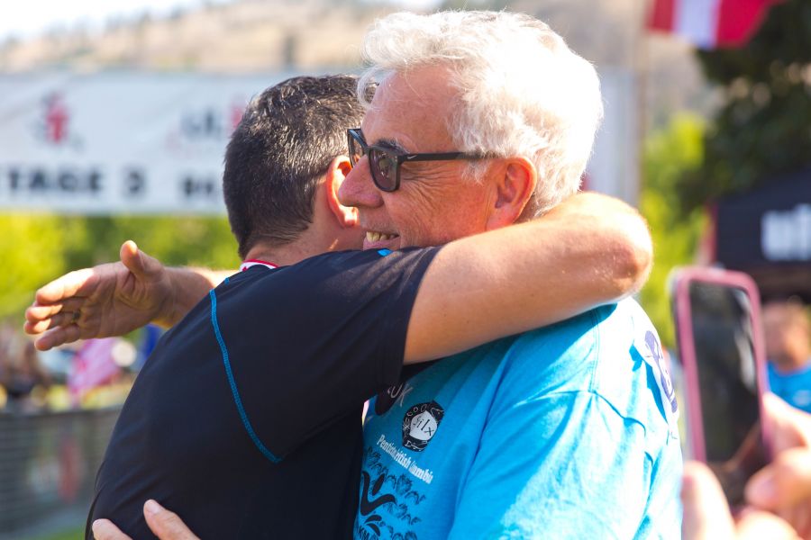 <who>Photo Credit: NowMedia</who> Steve Brown (right) gets a hug at the finish line