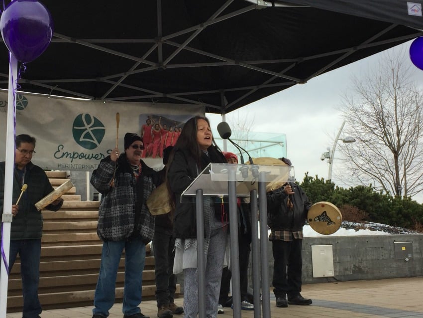 <who> Photo Credit: KelownaNow </who> Chief Roxanne Lindley of Westbank First Nation opened the event with the Women Warrior's song.