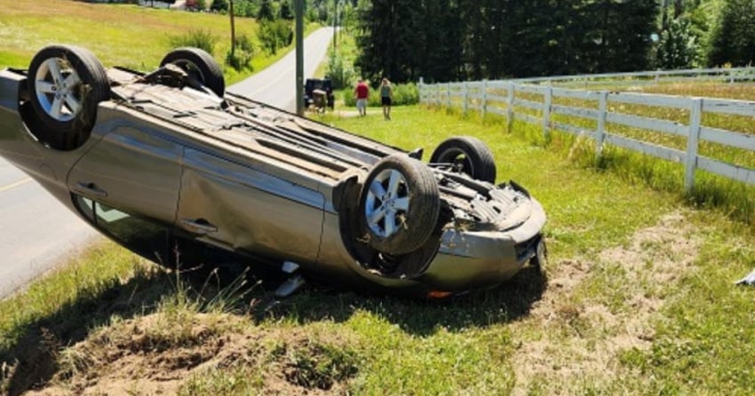 Bystander breaks rear window of flipped car to pull young child to safety