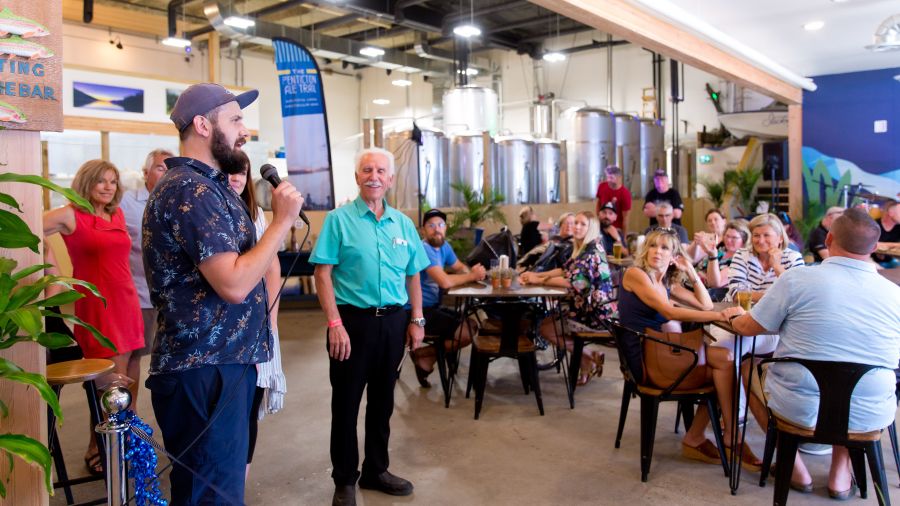 Liam Peyton at the mic at Slackwater's September grand opening ceremony