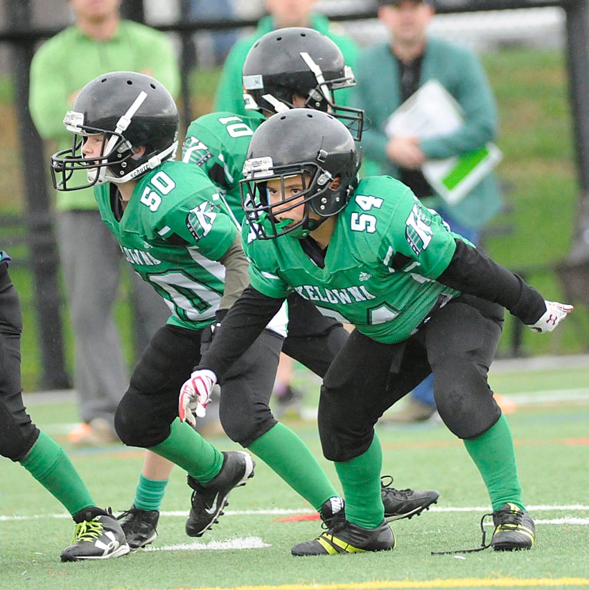 <who>Photo Credit: Lorne White/KelownaNow </who>Kelowna Riders' offensive line, including Lochlan Douglas (50) and Hayden Littlechild (54) provided room for their teammates to run on Sunday in their SIFC championship victory over the Kelowna Lions.