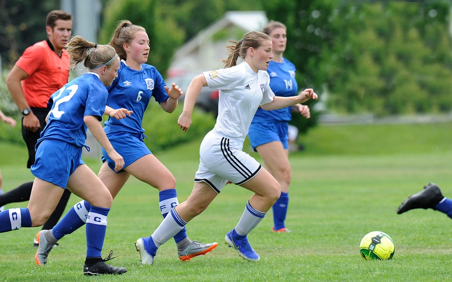 <who>Photo Credit: Lorne White/KelownaNow </who>Jordan King of TOFC gains possession among severval Coastal FC opponents. She went on to set up a goal by Sydney Kolodziej.
