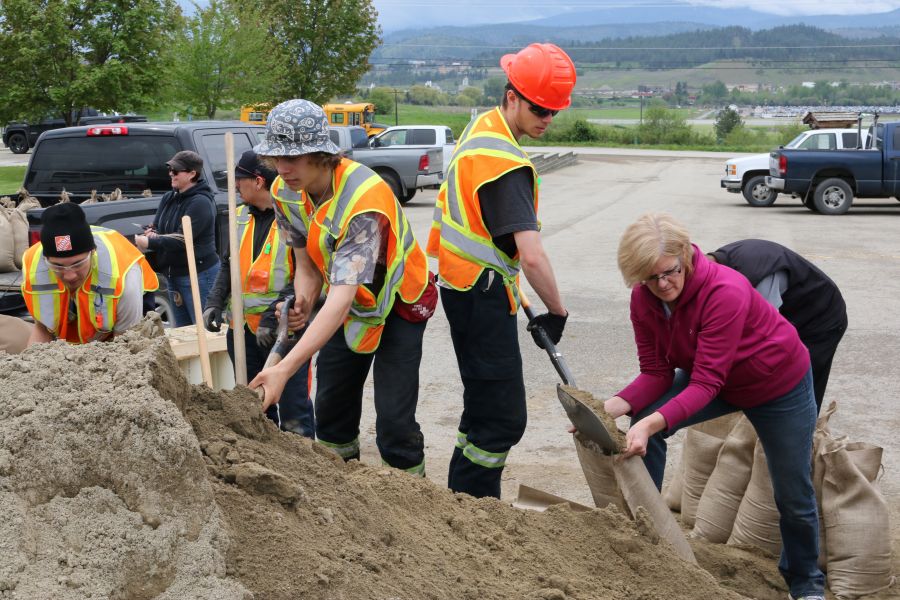 <who> Contributed </who> Forestry students Dawson Sullivan (left) and Dawson Hughes fill sandbags with their classmates from the RSS Forestry program.