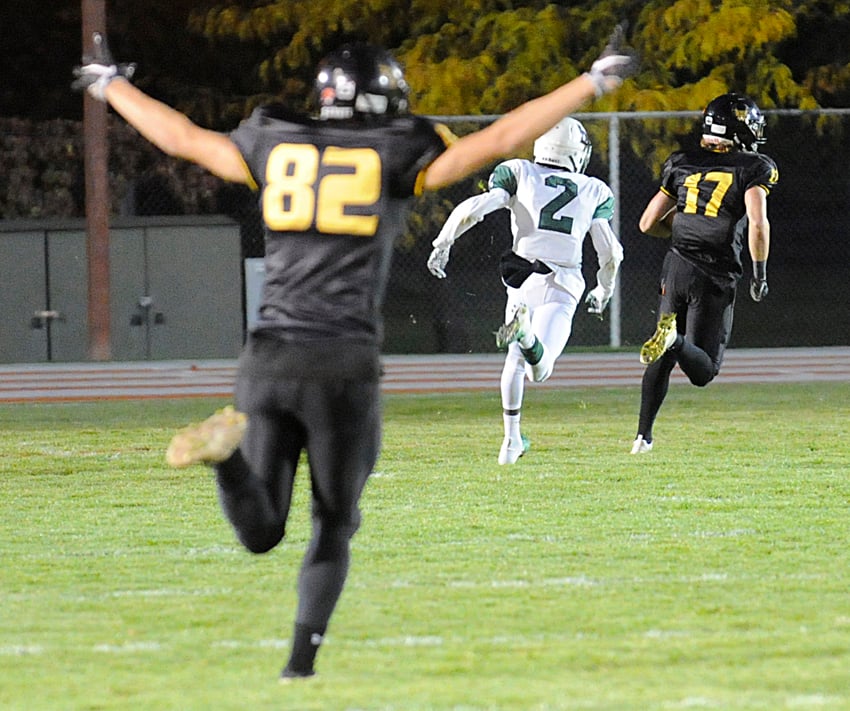 Rhys James (82) celebrates as teammate Nolan Ulm runs to the endzone for the Owls' first touchdown.