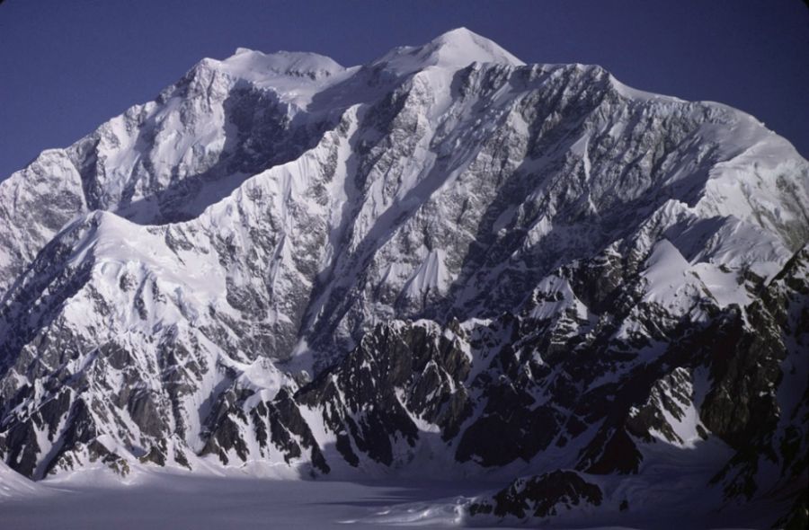 <who> Photo Credit: Gerald Holdsworth from the National Oceanic and Atmospheric Administration. </who> Mount Logan, Canada's highest peak, stands at 5,959 metres, and is part of the Saint Elias range in the Yukon.