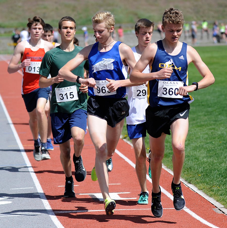 <who>Photo Credit: Lorne White/KelownaNow </who>Summerland's Keagan Ingram (963) and Michael Schriemer (360) check their watches at the start of the second lap of the junior/senior 3000-metre race.