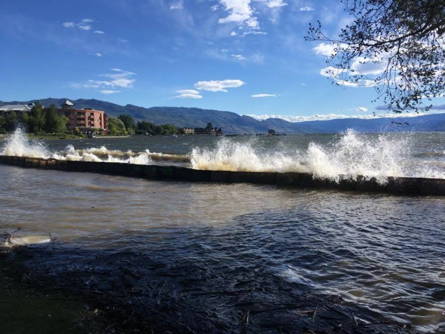 <who> Photo Credit: KelownaNow. </who> Strong waves pound Rotary Beach last Friday.