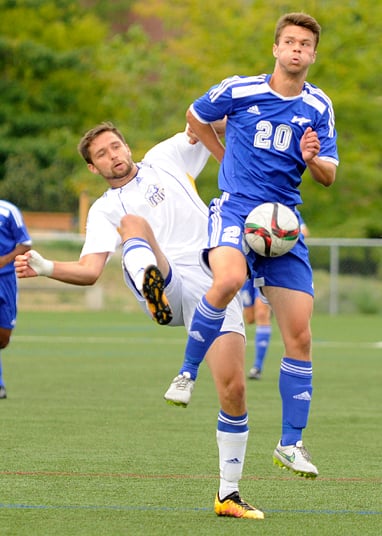 <who>Photo Credit: Lorne White/KelownaNow </who>Tyler Shalansky of the Heat cradles the ball on a goal kick in <br>front of a UBC T-Bird defender.