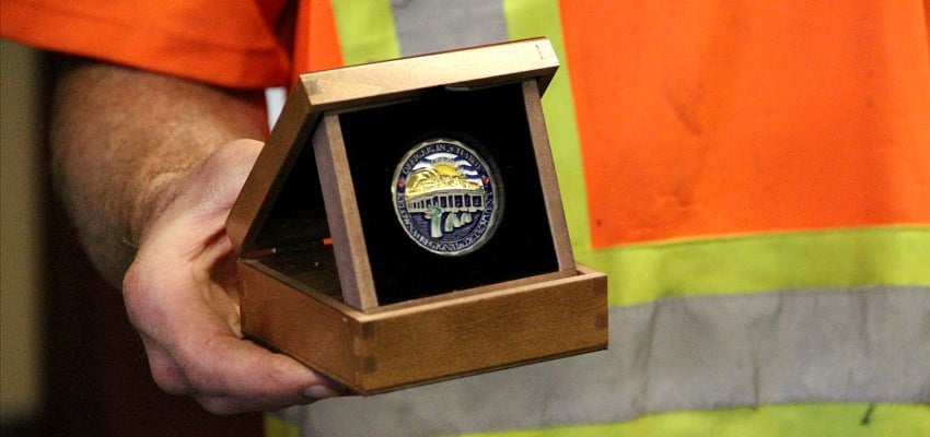 <who> Photo Credit: KelownaNow. </who> One of the Kelowna RCMP Challenge Coins. 