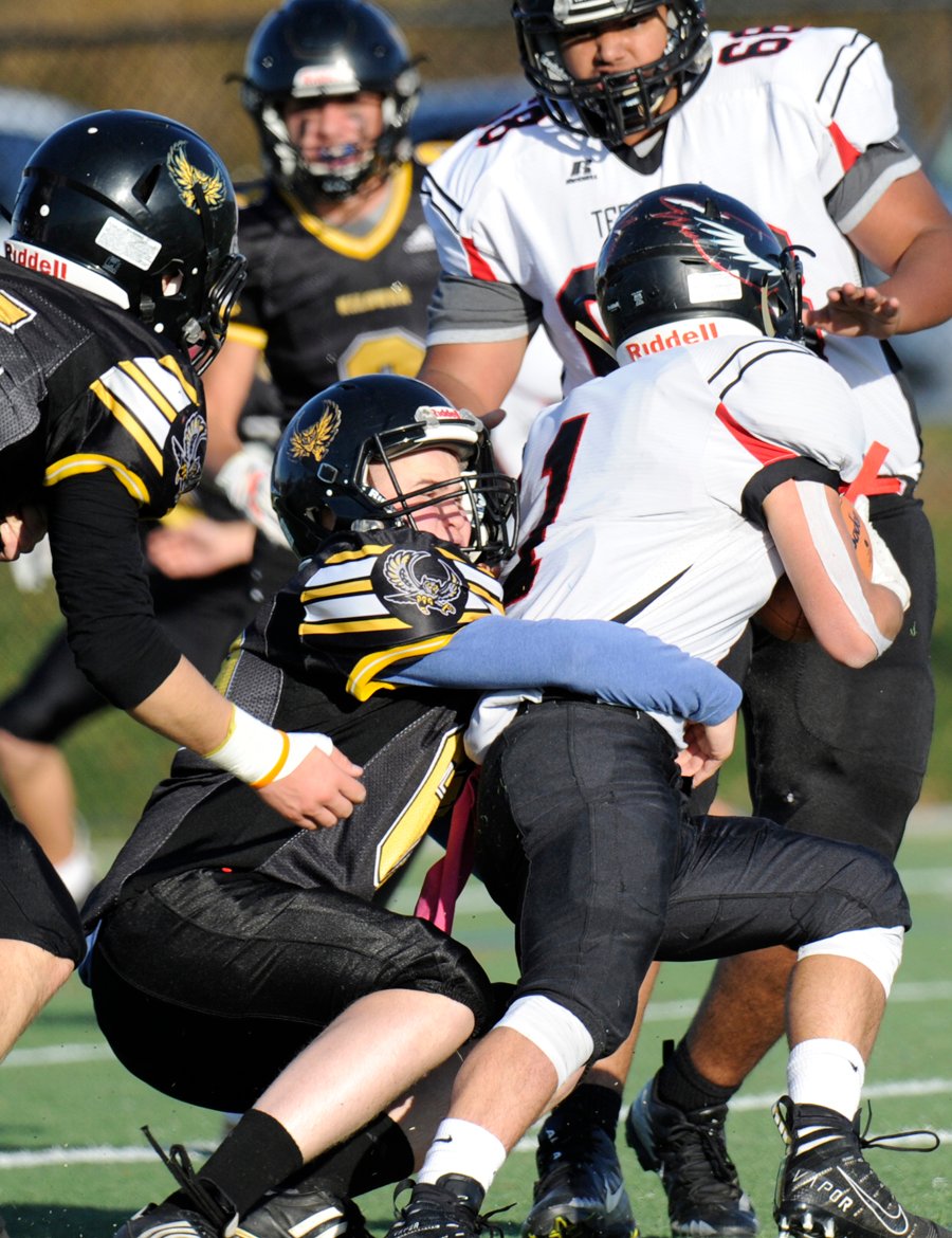 <who>Photo Credit: Lorne White/KelownaNow </who>Cole Rogers of the JV Owls brings down Terry Fox's Gavin Whittingham in the second quarter of the KSS playoff win at CNC Stadium.