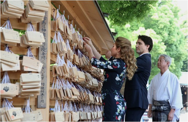 Trudeau and his wife Sophie hanging prayer tablets at the Meiji shrine on Tuesday morning.