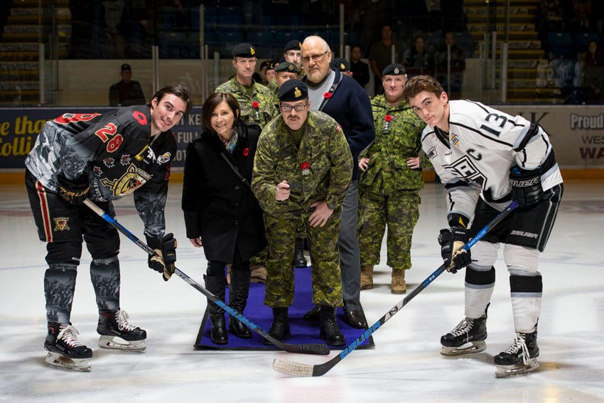 <who>Photo Credit: Julie Pringle/Snap Photography </who>Warriors captain Jared Marino takes a ceremonial opening puck drop with Silverbacks captain Grayson Constable. The B.C. Dragoons were among the Canadian military honoured during the BCHL game on Wednesday at Royal LePage Place. The Warriors wore special commemorative jerseys for one night only to pay their respects to the veterans. The jerseys are available for auction through the Warriors' website.