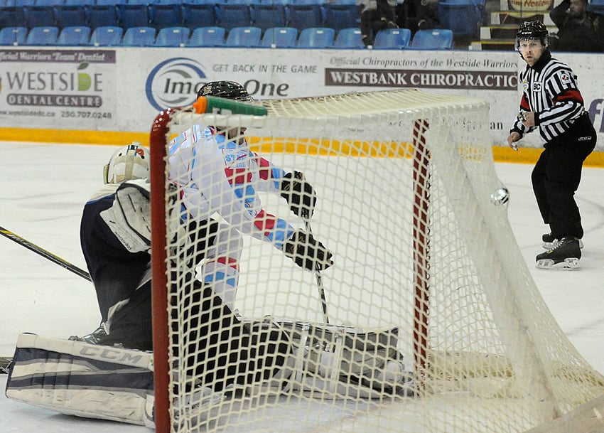 <who>Photo Credit: Lorne White/KelownaNow.com </who>Brett Mennear bulges the Langley Rivermen net with his backhand shot in the first period. 