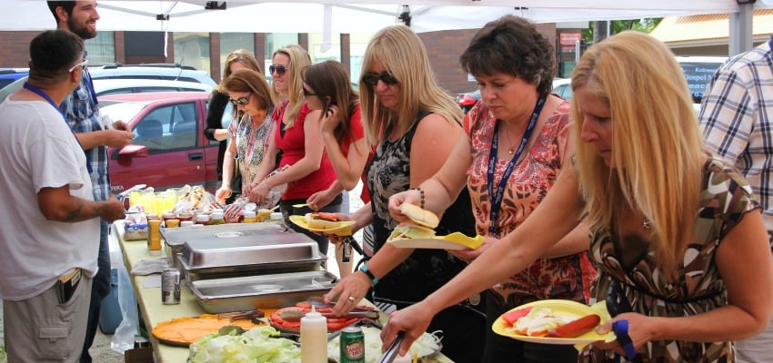 <who> Photo Credit: KelownaNow. </who> Members of various agencies gathered at Kelowna's Gospel Mission on Wednesday to enjoy a special barbecue. 