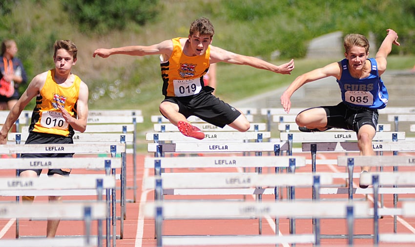 <who>Photo Credit: Lorne White/KelownaNow </who>From left, Joel Aiken (KSS), Stephen Kucher (KSS) and Noah Russell (Const. Neil Bruce) head to the finish line in the junior boys 100-metre hurdles. Russell edged Kucher for first place and Aitken placed third.