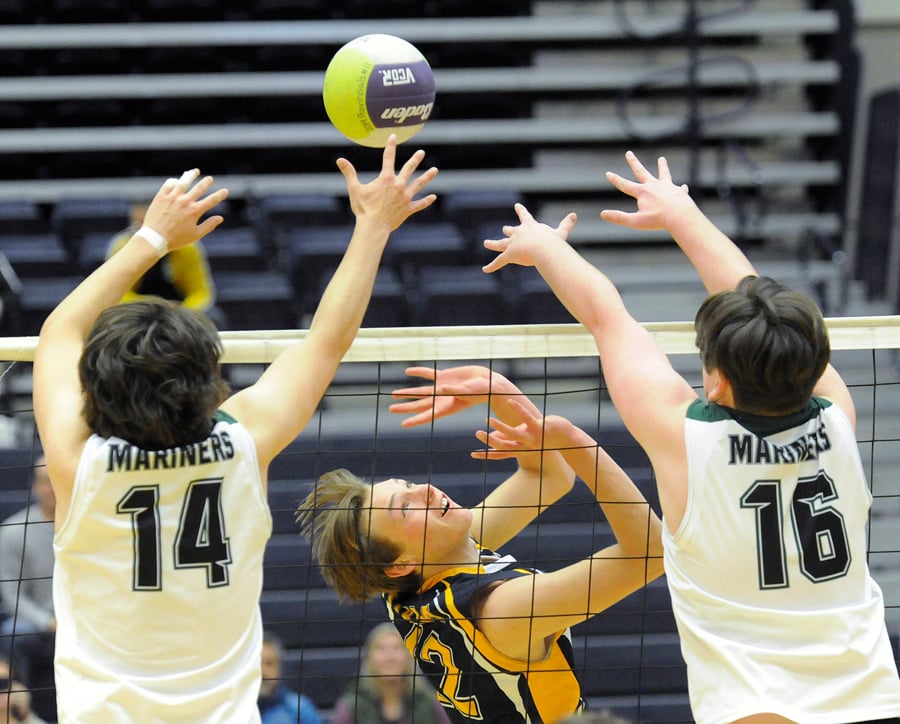 Aaron Saufferer of the OKM Huskies sets the ball over an Earl Marriott block in semifinal play.