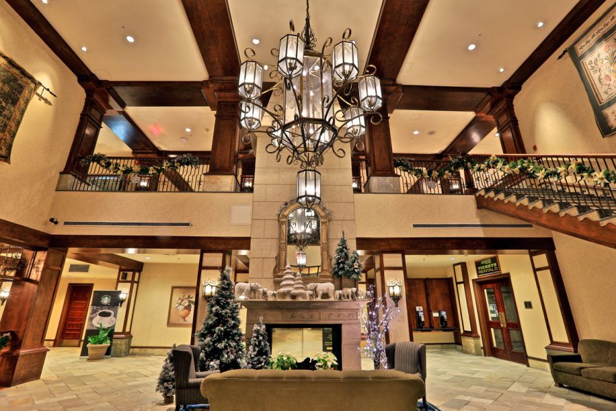 <who>Photo Credit: KelownaNow / KamloopsBCNow</who> The lobby of the Sun Peaks Grand Hotel cuts an impressive figure with soaring ceilings, woodwork and a warm fireplace.