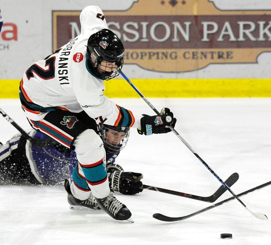 <who>Photo Credit: Lorne White/KelownaNow </who>The OK Rockets' Riley Dobranski beats a South Island Royals to the puck in the second period on Sunday.