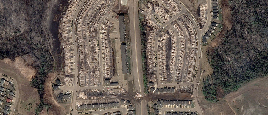 <who> Photo Credit: Alberta Government </who> A satellite image of Fort McMurray is available for resident to survey the damage to their community. 