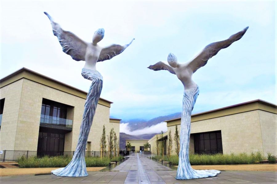 </who> The sculpture by Wu Ching Ru that flanks the main entrance of Phantom Creek Winery in Oliver.