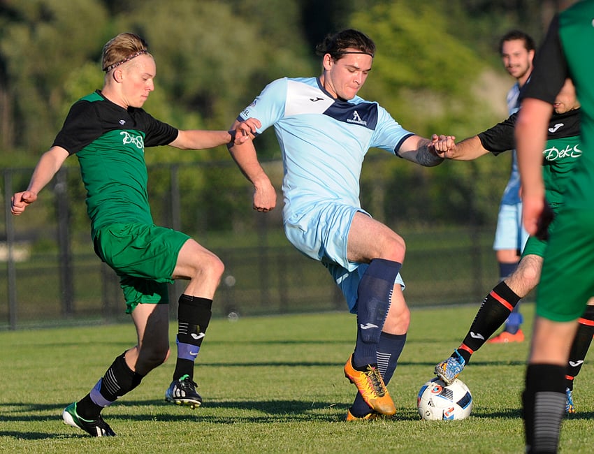 <who>Photo Credit: Lorne White/KelownaNow </who>DekSmart's Ben Lommer, left, and Okanagan FC's in sync playing the ball in Monday's KMSL Division 1 match.