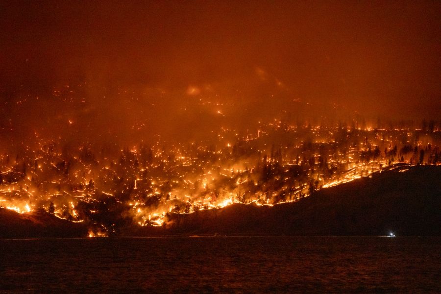 <who>Photo Credit: KelownaNow</who>The McDougall Creek wildfire burning on the west shores of Okanagan Lake, north of the bridge, late Thursday night.