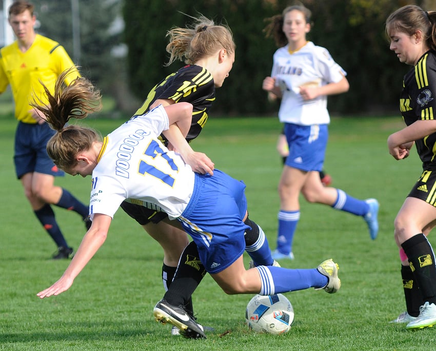 <who>Photo Credit: Lorne White/KelownaNow </who>The Rutland Voodoos' Josie Stutters (foreground) gets tangled up with Natalie Hope of the Kelowna Owls in the second half of their Okanagan Valley league game on Monday at Rutland Sportsfields.