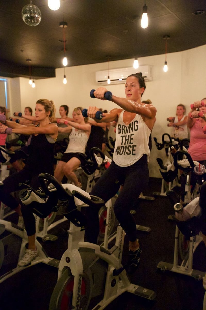 SPINCO Kelowna adds hand weights to the workout to work arms and core as well.