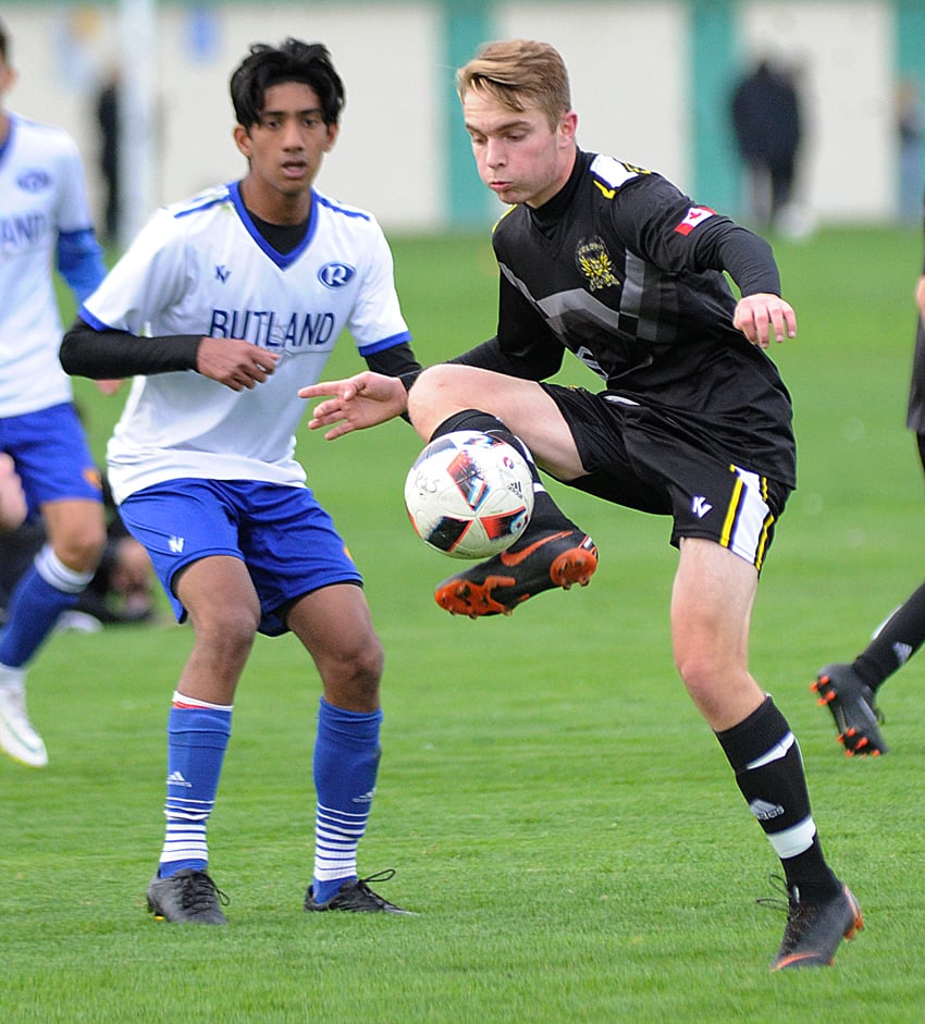 Chris West of the Owls settles the ball in front of the Voodoos' Parm Parmar.