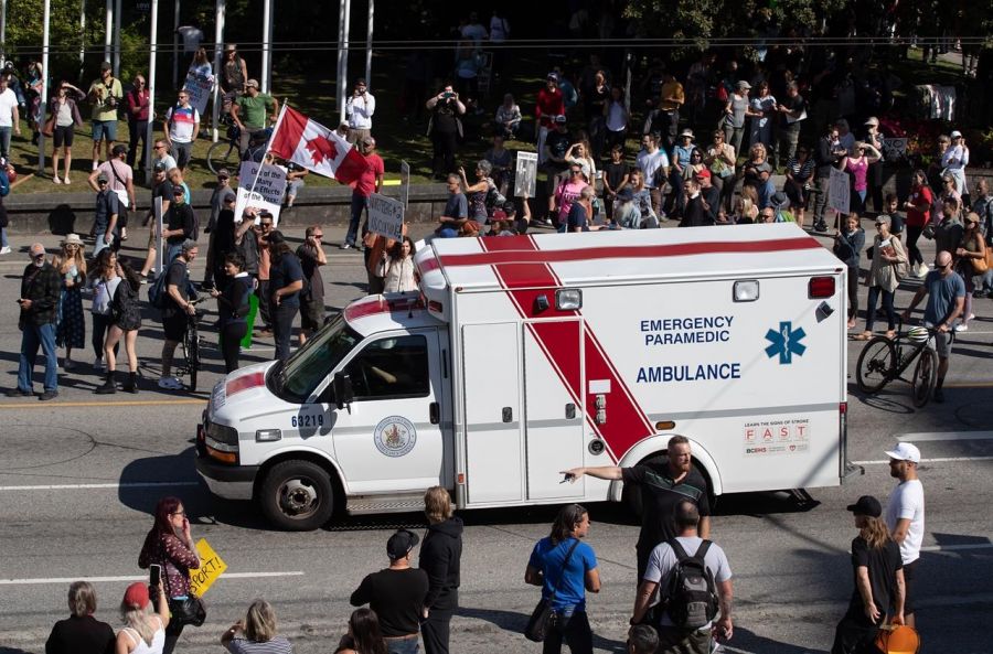 <who>Photo Credit: Canadian Press</who>An ambulance passes through the crowd at a protest in Vancouver earlier this month.