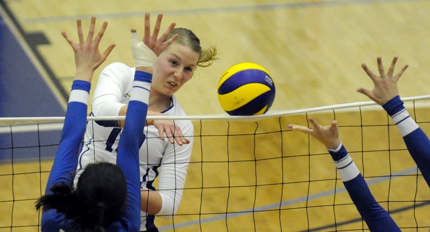 <who>Photo Credit: Lorne White/KelownaNow.com </who>Middle Katy Klomps powers the ball off the net for one of her six kills in the Final Four semifinal.