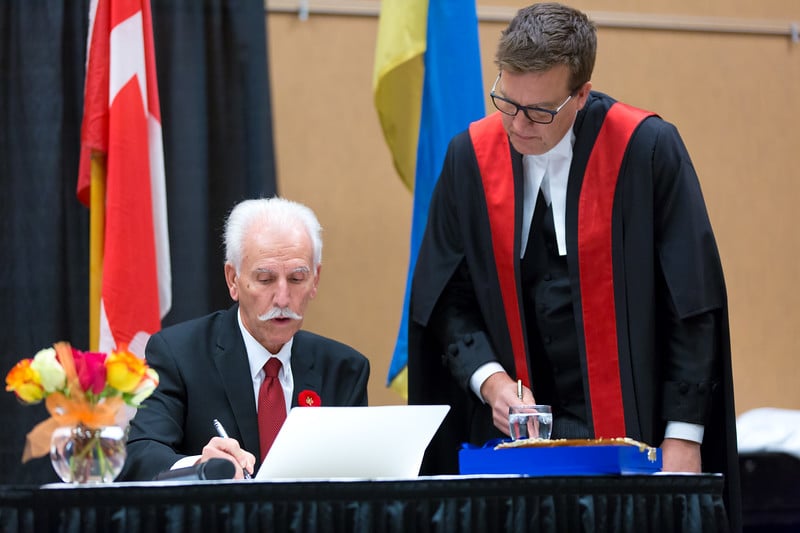 <who>Photo Credit: NowMedia </who>Penticton's new Mayor John Vassilaki swore an official oath of office in front of Provincial Court Judge Gregory Koturbash Tuesday evening at the Penticton Trade and Convention Centre.