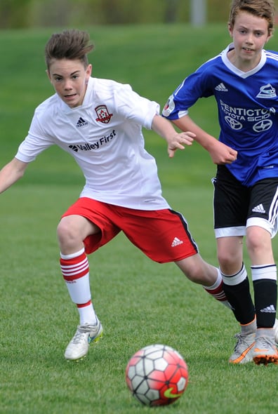 <who>Photo Credit: Lorne White/KelownaNow </who>Midfielder Zack MacInnes, left, sets up a United teammate with a <br>lead pass during their TOYSL U14 match at Mission Sportsfields.