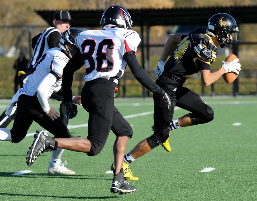 Jackson Saini runs for a first down and more after catching an early pass from quarterback Jaeke Schlachter in the Kelowna Owls' junior varsity playoff win over the visiting Terry Fox Ravens.