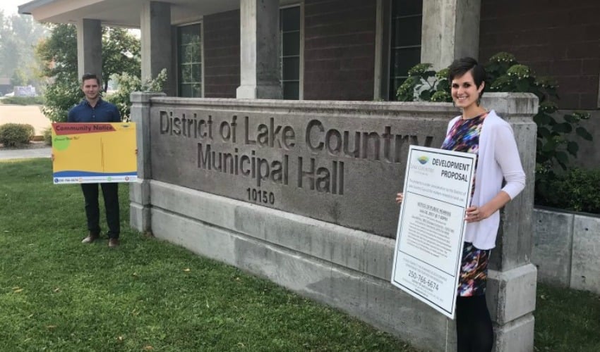 <who> Photo Credit: District of Lake Country </who> AJ Taylor and Jocelyn Ratzlaff display new and old signage.