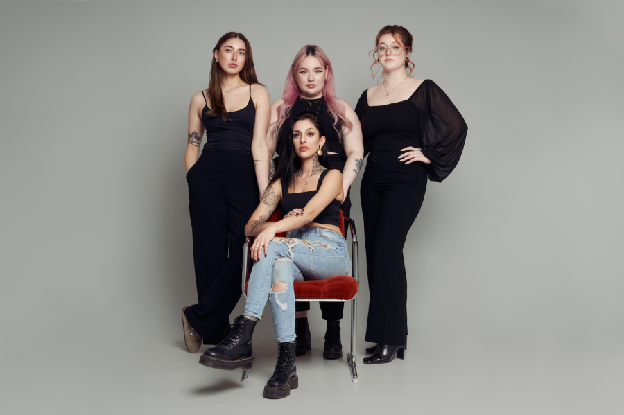 <who> Photo Contributed by Luar Body Piercing </who> Studio Operations Manager, Chloe (left); Apprentice Body Piercer, Harleigh (back-center); Owner and Senior Body Piercer, Sea (front-center); Social Media/ Marketing Director, Adi (right). 